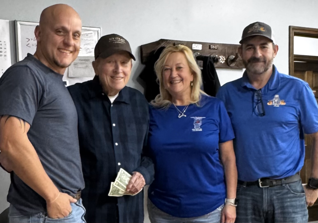 A picture of the founder of Lewis Fire Protection, Walter Lewis (second from the left) with some staff members.