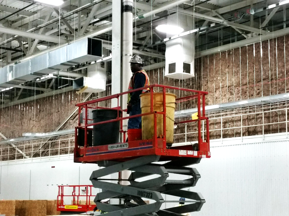 A man operating an aerial lift.