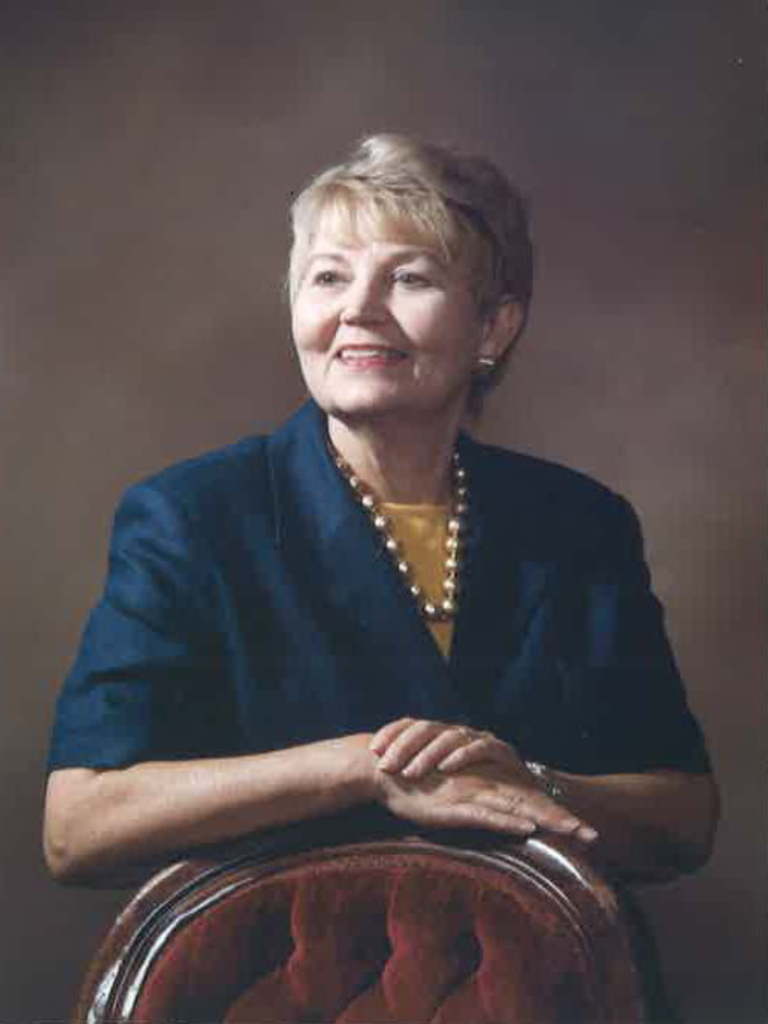 Marie Lewis, Co-Founder of Lewis Fire Protection sitting at his desk.
